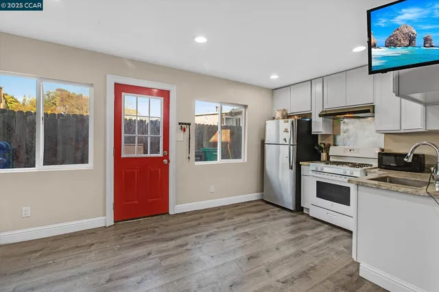 a bathroom with a sink vanity and a shower
