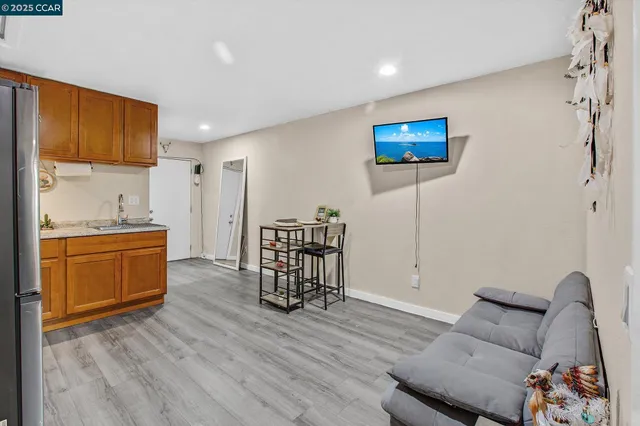 a living room with furniture a couch and a flat screen tv