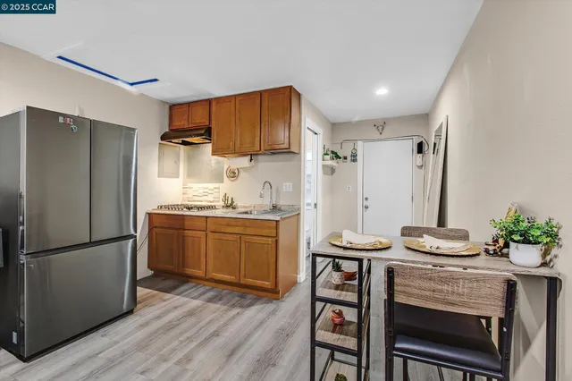 a kitchen with stainless steel appliances a refrigerator and a stove top oven