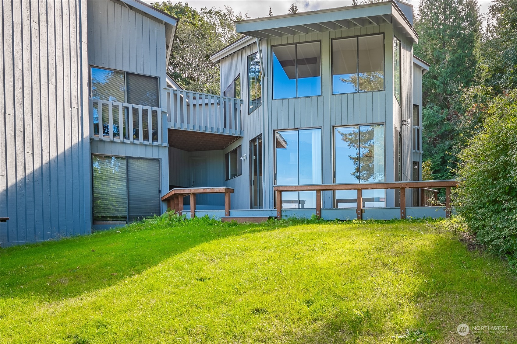 a view of a house with a yard and sitting area