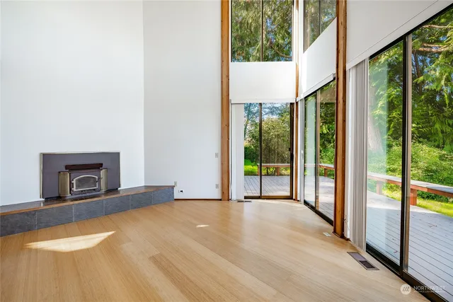 a view of an empty room with a fireplace and a window