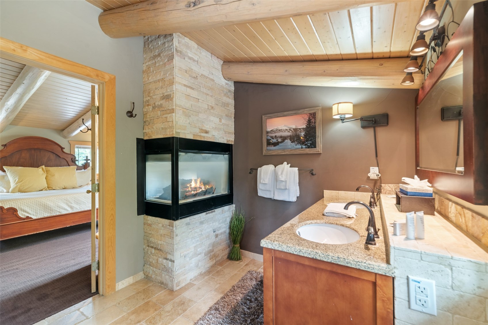 243 Rena Road Breckenridge, CO 80424 - Photo 11 of 50 Bathroom featuring dual vanity, vaulted ceiling with beams, a fireplace, and wood ceiling