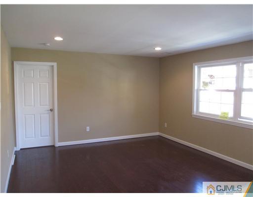 18 Colton Road Edison, NJ 08817 - Photo 3 of 10 an empty room with wooden floor and windows