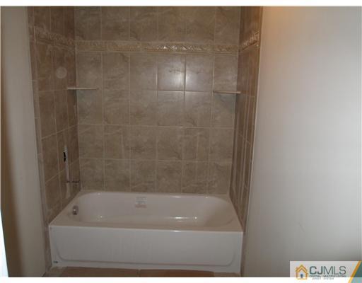 18 Colton Road Edison, NJ 08817 - Photo 7 of 10 a bathroom with a bath tub and shower