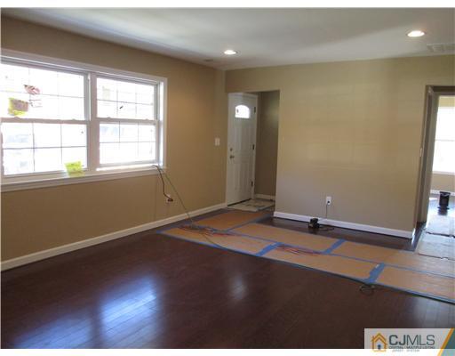 18 Colton Road Edison, NJ 08817 - Photo 10 of 10 an empty room with wooden floor and windows