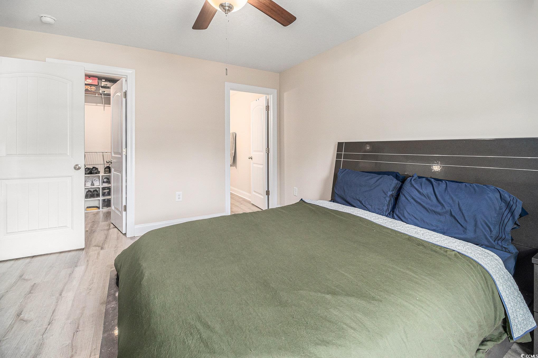 2521 Wise Road Conway, SC 29526 - Photo 10 of 20 Bedroom featuring a walk in closet, light wood-type flooring, baseboards, a closet, and ceiling fan