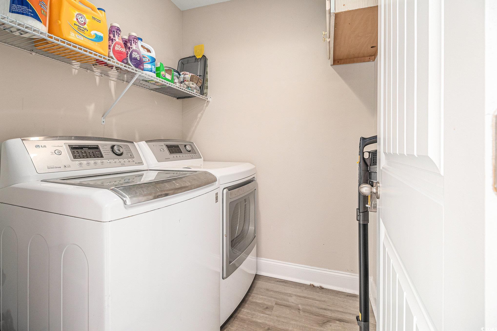 2521 Wise Road Conway, SC 29526 - Photo 17 of 20 Clothes washing area featuring washing machine and clothes dryer, light wood-style floors, and baseboards