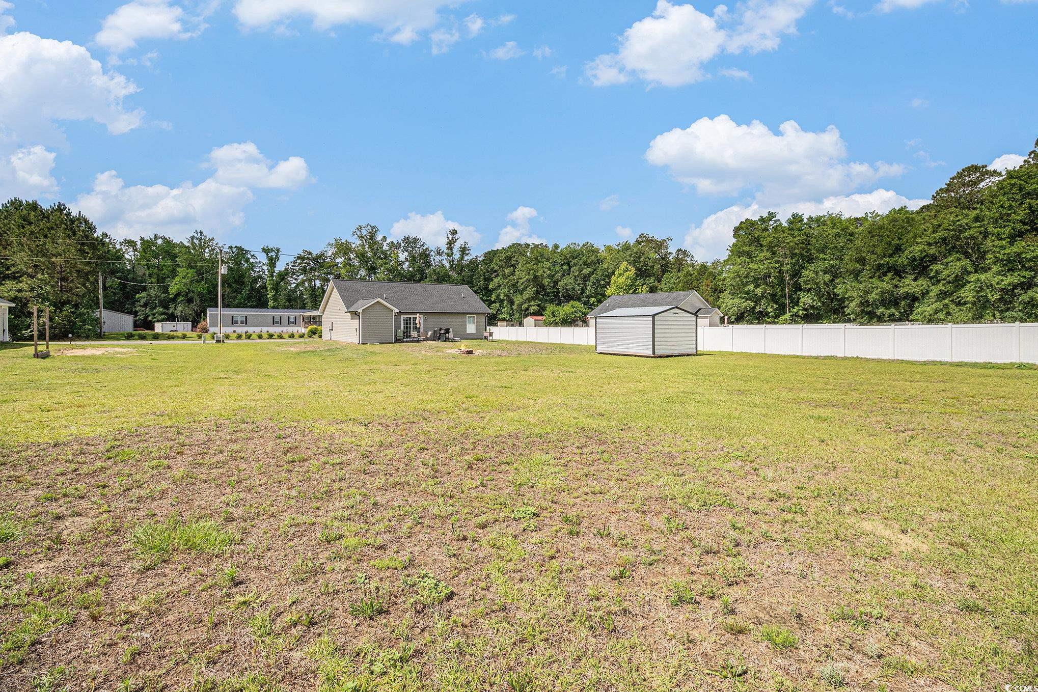 2521 Wise Road Conway, SC 29526 - Photo 19 of 20 View of yard featuring a storage shed, an outbuilding, and a detached garage