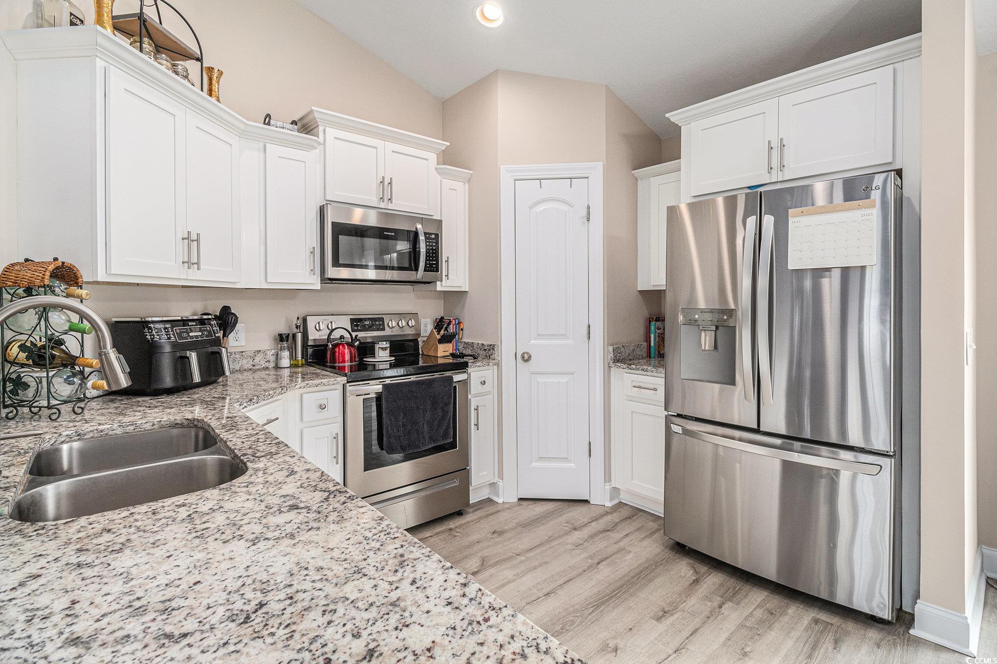 2521 Wise Road Conway, SC 29526 - Photo 7 of 20 Kitchen featuring appliances with stainless steel finishes, lofted ceiling, white cabinets, light wood-style flooring, and recessed lighting