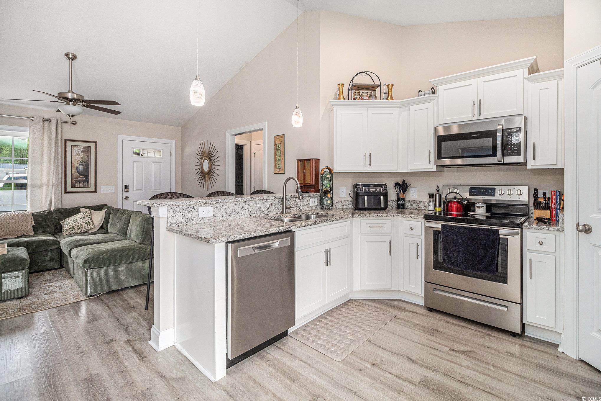 2521 Wise Road Conway, SC 29526 - Photo 20 of 20 Kitchen with stainless steel appliances, a sink, open floor plan, a peninsula, and ceiling fan