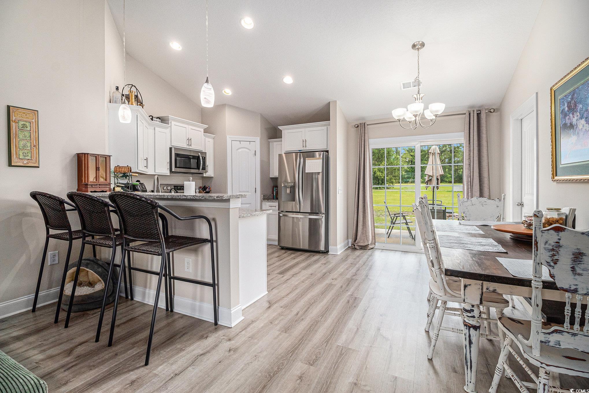 2521 Wise Road Conway, SC 29526 - Photo 8 of 20 Kitchen featuring appliances with stainless steel finishes, lofted ceiling, a chandelier, a peninsula, and white cabinets