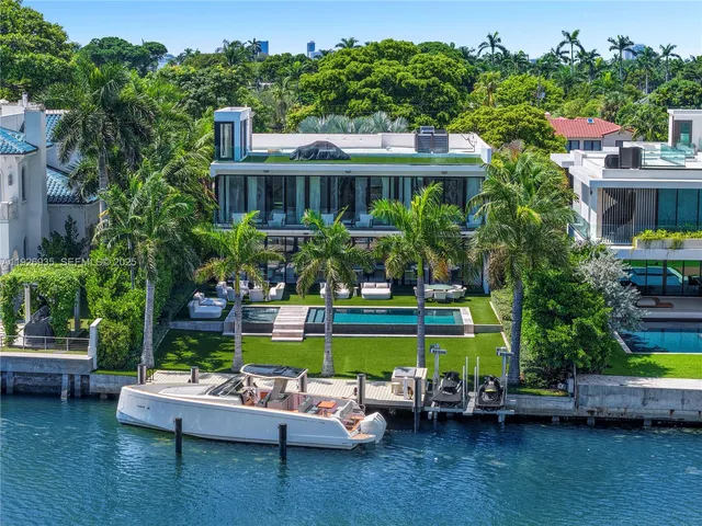 a house view with swimming pool and garden view