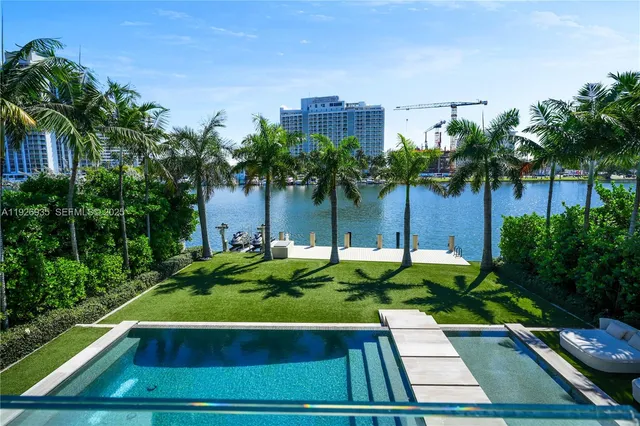 a bedroom with a large bed and a flat tv screen