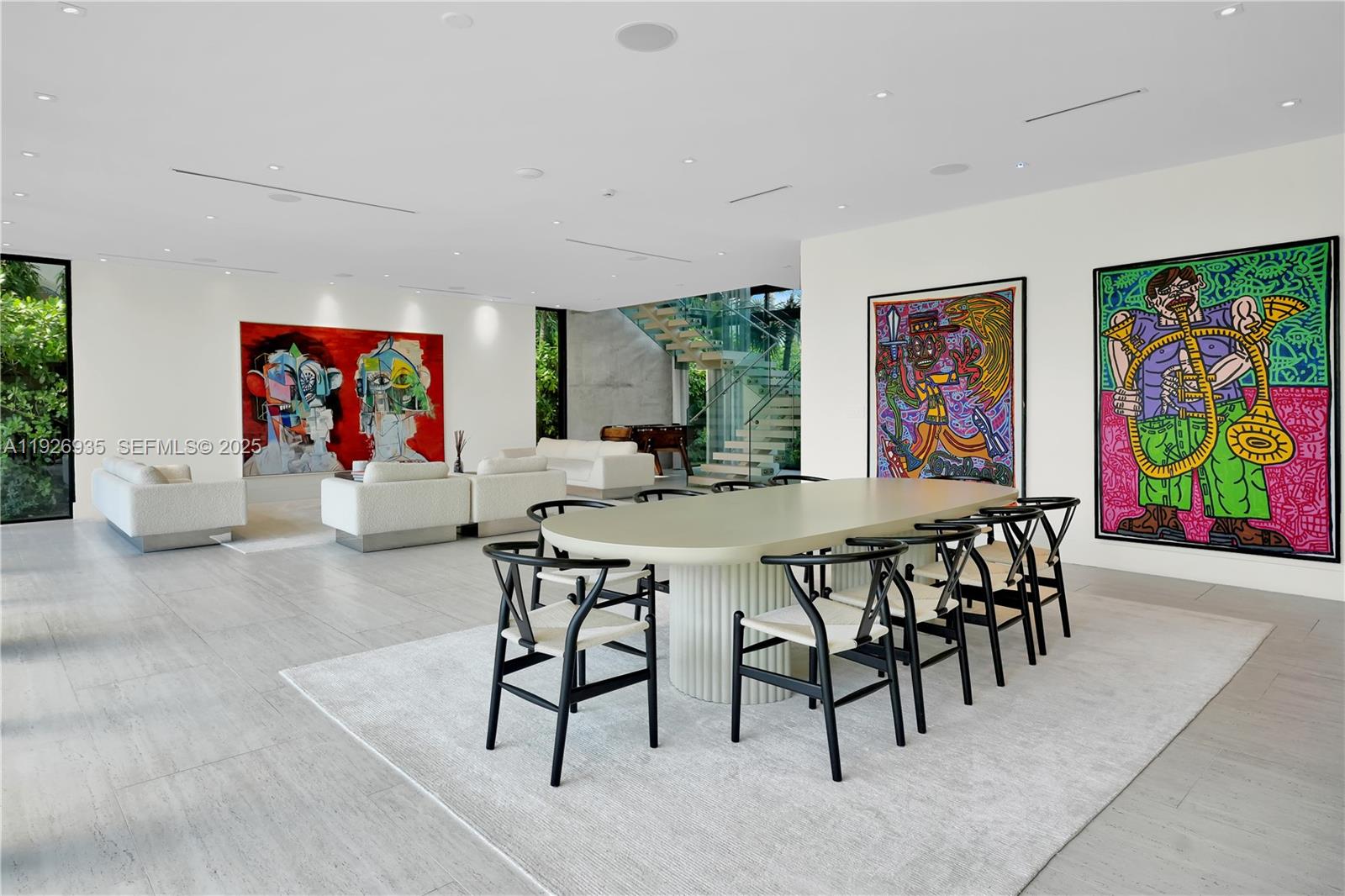 5501 Pine Tree Drive Miami Beach, FL 33140 - Photo 22 of 60 a view of a dining room with furniture a rug and a window