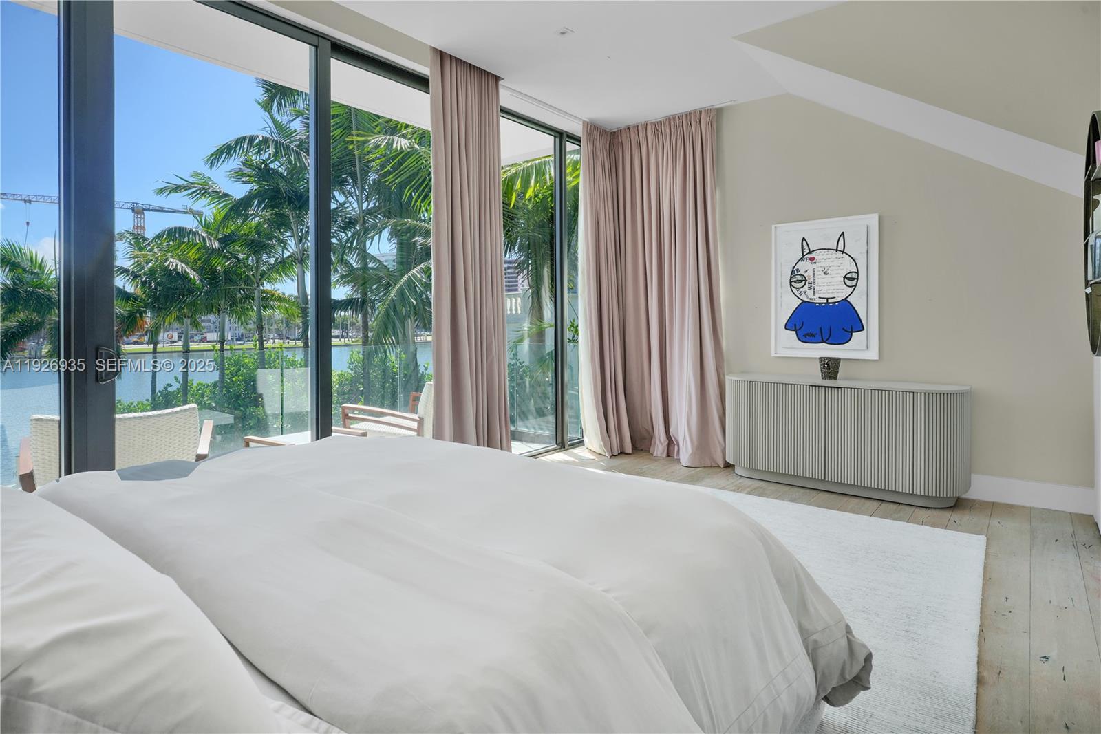 5501 Pine Tree Drive Miami Beach, FL 33140 - Photo 39 of 60 a bedroom with a large bed and a large window