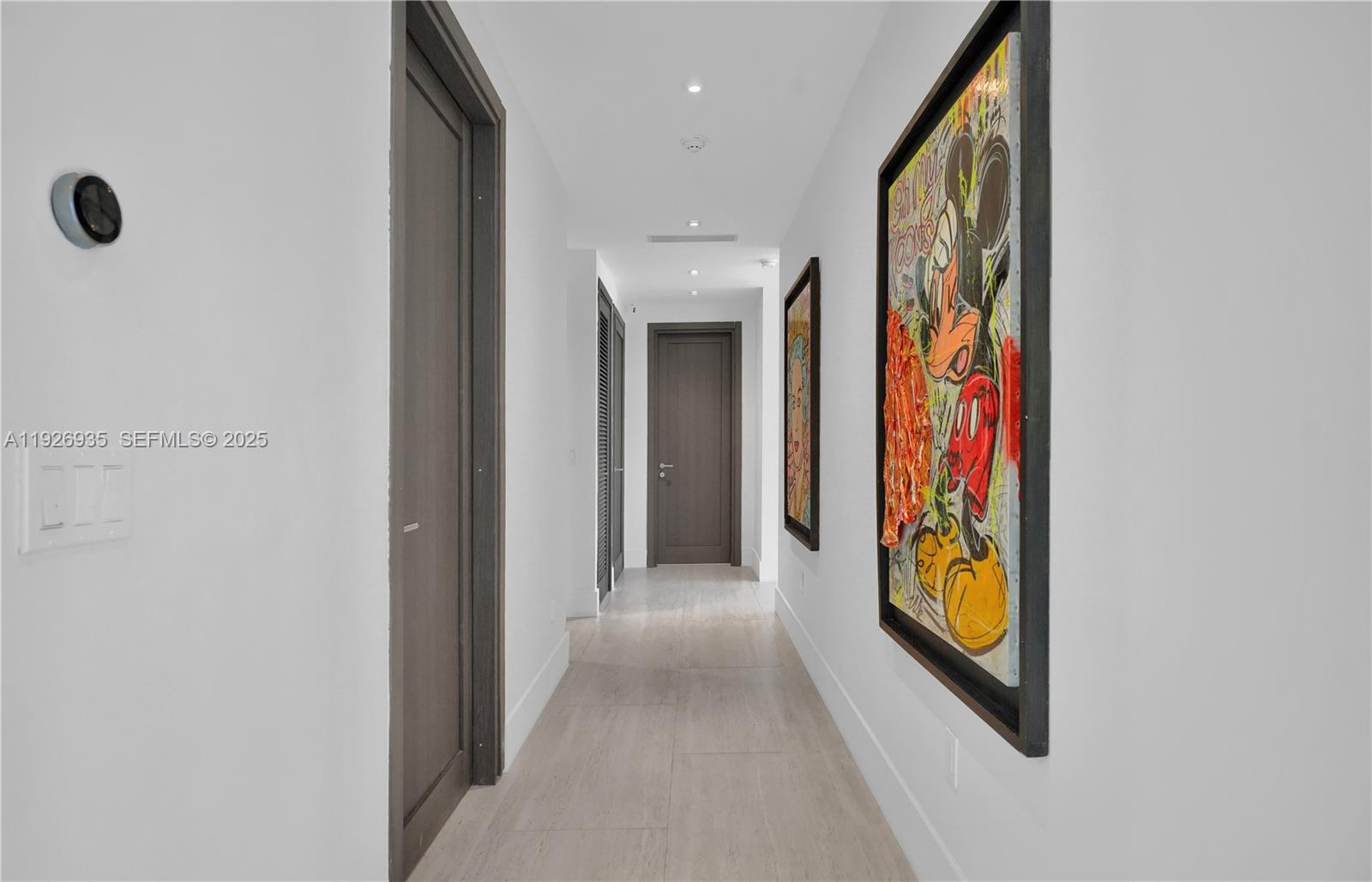 5501 Pine Tree Drive Miami Beach, FL 33140 - Photo 43 of 60 a view of a hallway with painted walls and a window