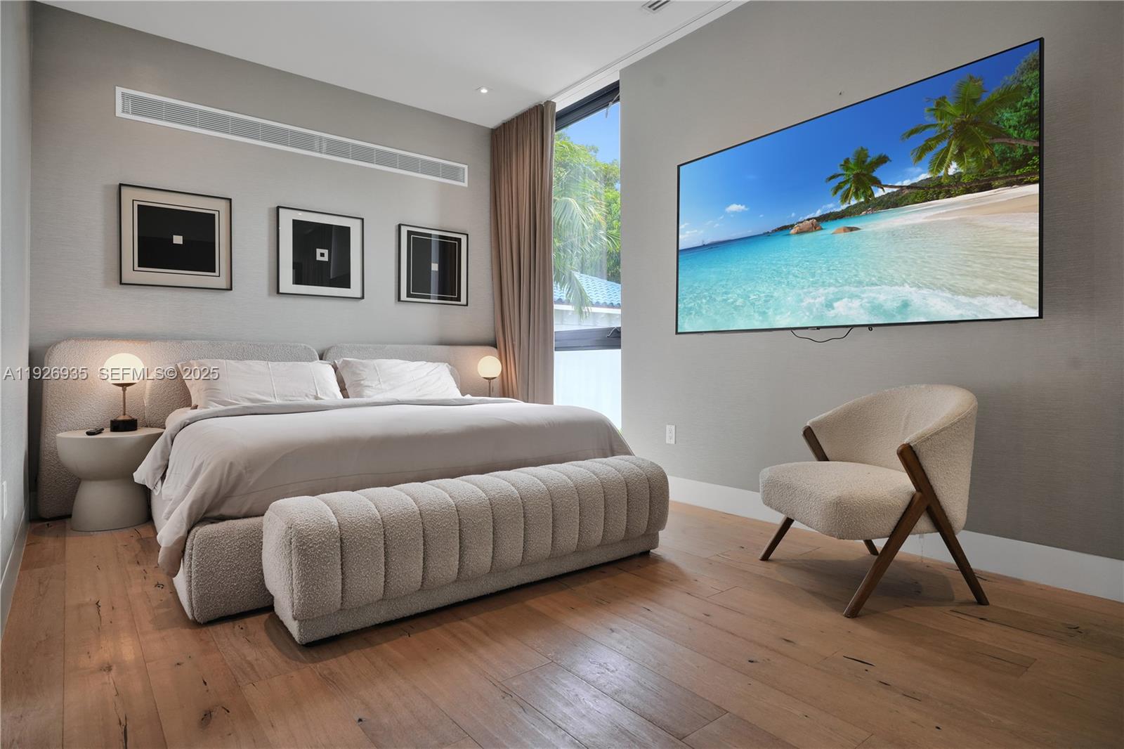 5501 Pine Tree Drive Miami Beach, FL 33140 - Photo 45 of 60 a bedroom with a bed and a chair