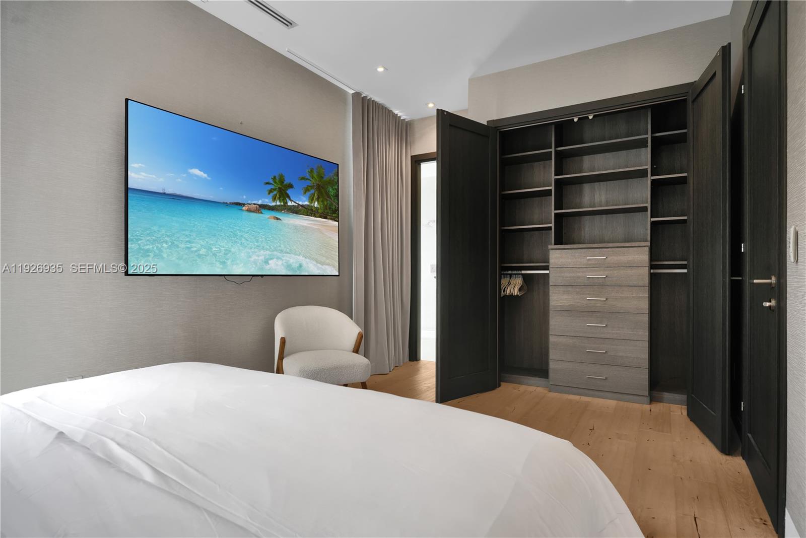 5501 Pine Tree Drive Miami Beach, FL 33140 - Photo 47 of 60 a bedroom with a bed and a window