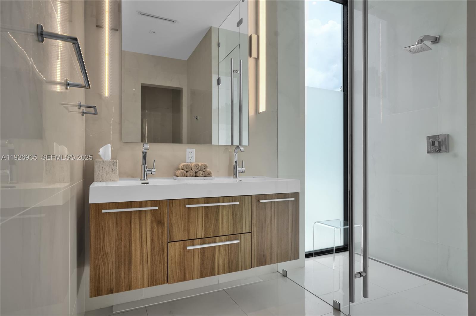 5501 Pine Tree Drive Miami Beach, FL 33140 - Photo 48 of 60 a bathroom with a sink and a mirror