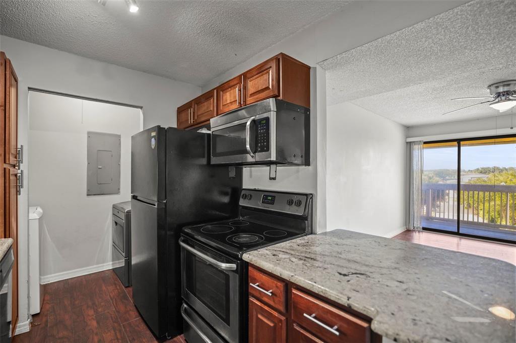 455 Alt 19, Unit 175 Palm Harbor, FL 34683 - Photo 11 of 35 a kitchen with stainless steel appliances granite countertop a stove a refrigerator and a sink