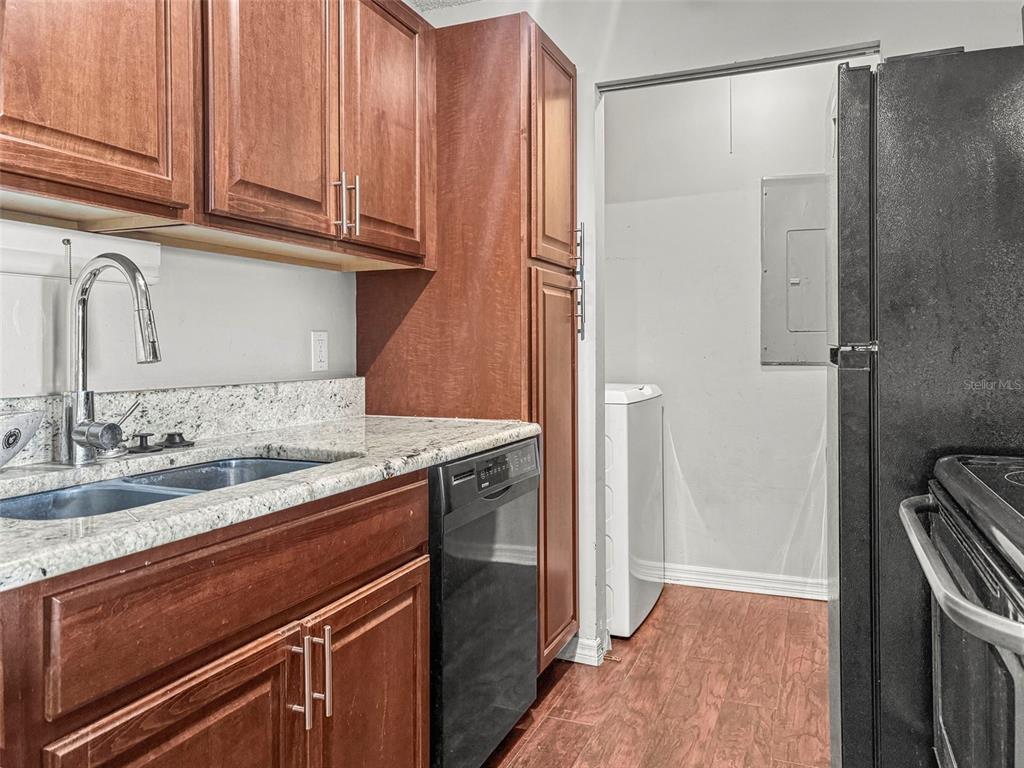 455 Alt 19, Unit 175 Palm Harbor, FL 34683 - Photo 12 of 35 a kitchen with a sink and a refrigerator
