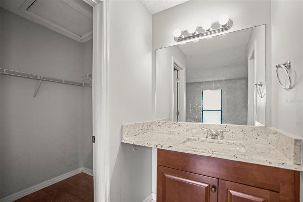 455 Alt 19, Unit 175 Palm Harbor, FL 34683 - Photo 20 of 35 a bathroom with a granite countertop sink and a mirror