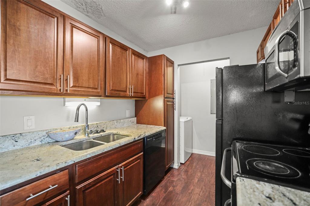 455 Alt 19, Unit 175 Palm Harbor, FL 34683 - Photo 3 of 35 a kitchen with stainless steel appliances granite countertop a sink stove and refrigerator