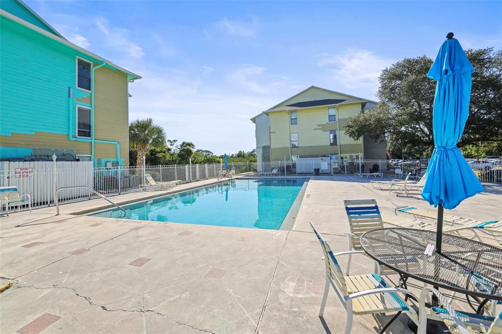 455 Alt 19, Unit 175 Palm Harbor, FL 34683 - Photo 35 of 35 a view of a swimming pool with a lounge chairs