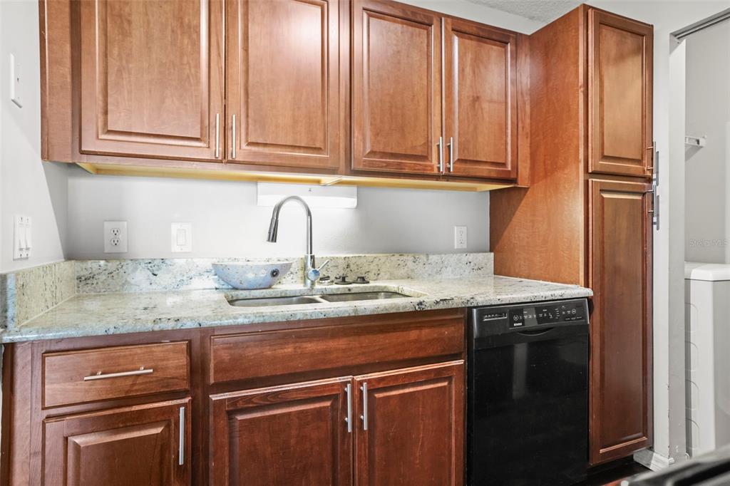 455 Alt 19, Unit 175 Palm Harbor, FL 34683 - Photo 4 of 35 a kitchen with granite countertop stainless steel appliances a sink and cabinets