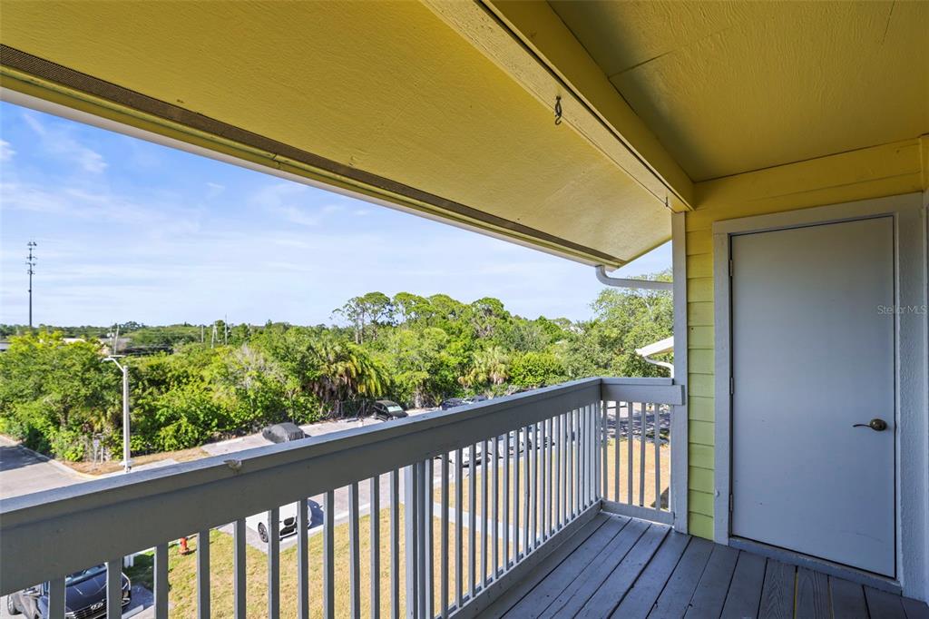 455 Alt 19, Unit 175 Palm Harbor, FL 34683 - Photo 9 of 35 a view of a balcony with wooden floor