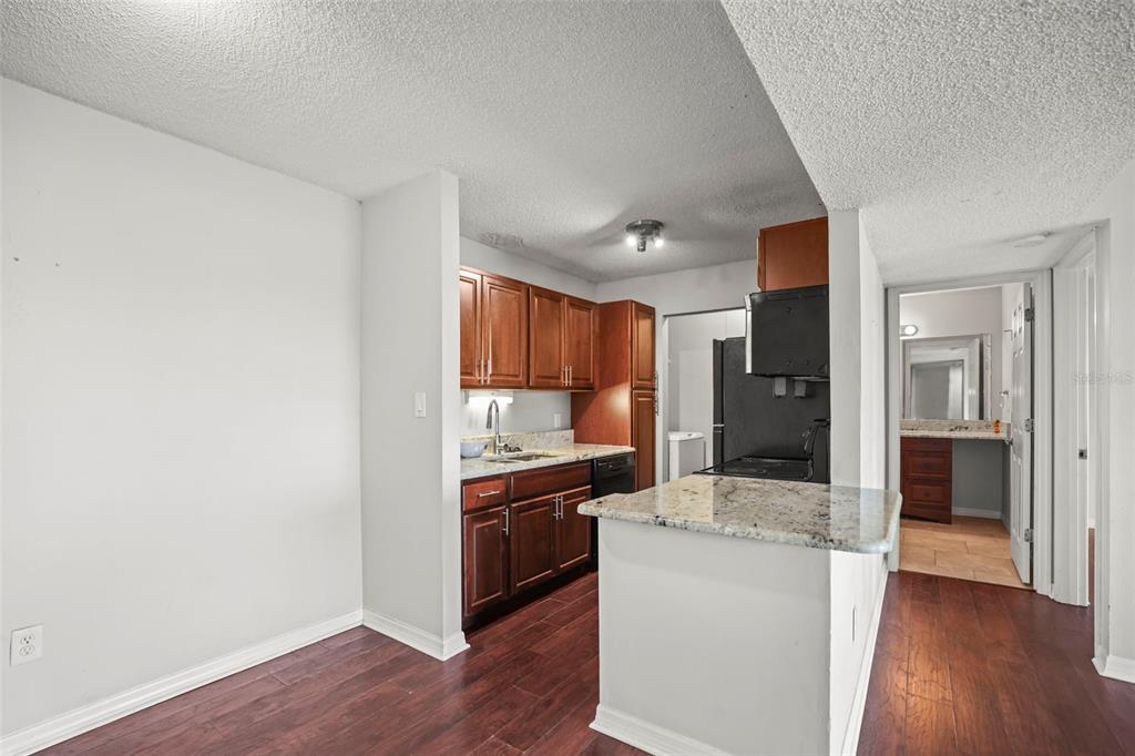 455 Alt 19, Unit 175 Palm Harbor, FL 34683 - Photo 10 of 35 a kitchen with a sink and a refrigerator