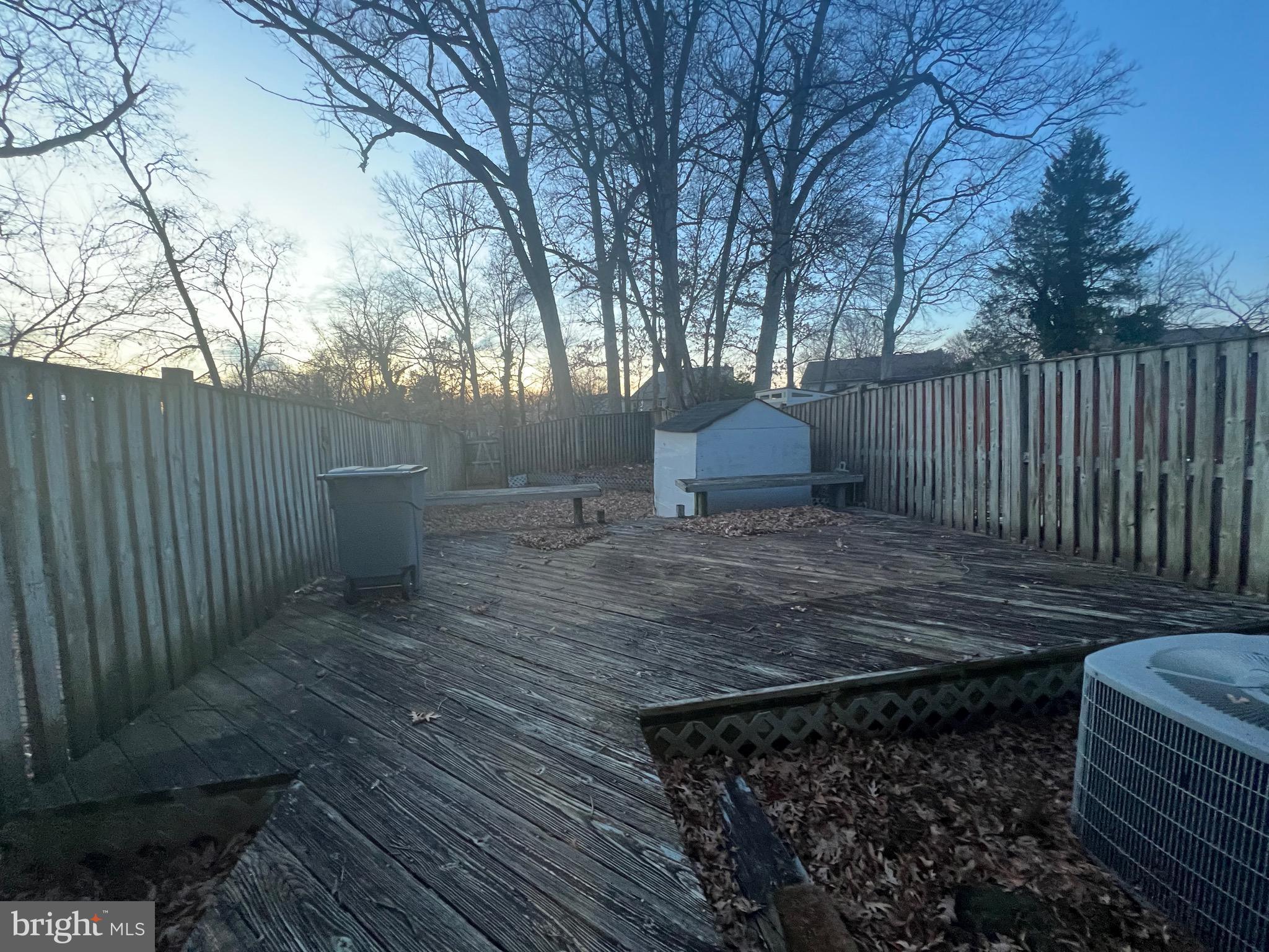 18804 Creeper Lane Gaithersburg, MD 20879 - Photo 18 of 20 a view of a backyard with wooden fence and trees