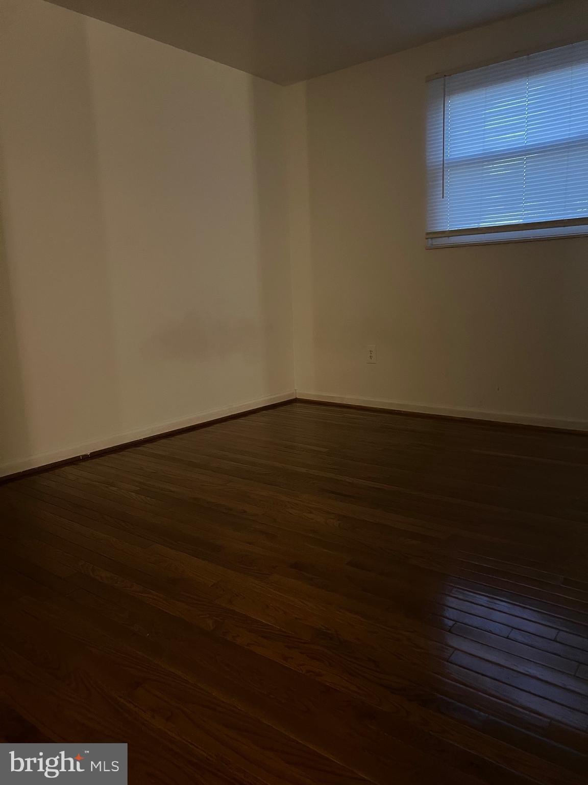 18804 Creeper Lane Gaithersburg, MD 20879 - Photo 7 of 20 a view of an empty room with wooden floor and a window