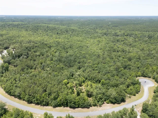 a view of a field with an ocean view