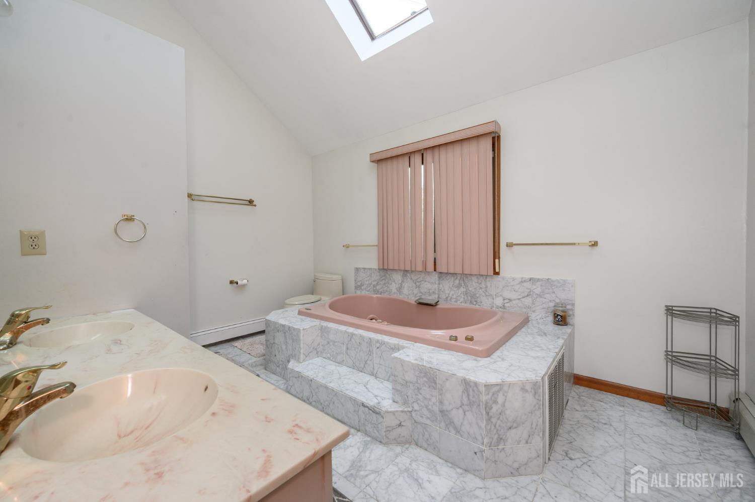 4 Drinking Brook Road Monmouth Junction, NJ 08852 - Photo 25 of 70 a bath tub sitting in a bathroom next to a sink