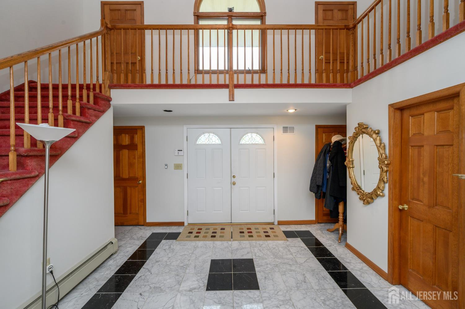 4 Drinking Brook Road Monmouth Junction, NJ 08852 - Photo 4 of 70 a view of a hallway with wooden floor and a rug