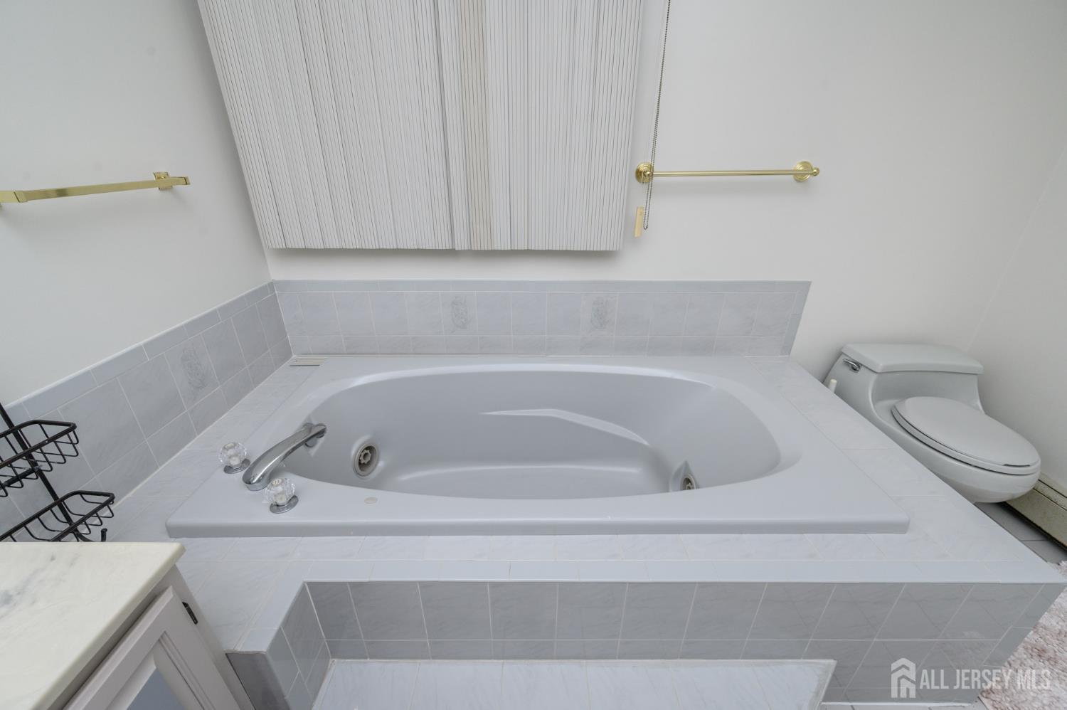 4 Drinking Brook Road Monmouth Junction, NJ 08852 - Photo 44 of 70 a bath tub sitting next to a white toilet and vanity