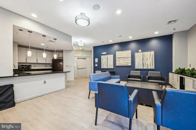 a large white kitchen with a view of living room