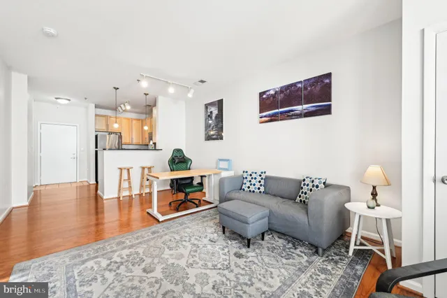 a living room with furniture and a wooden floor
