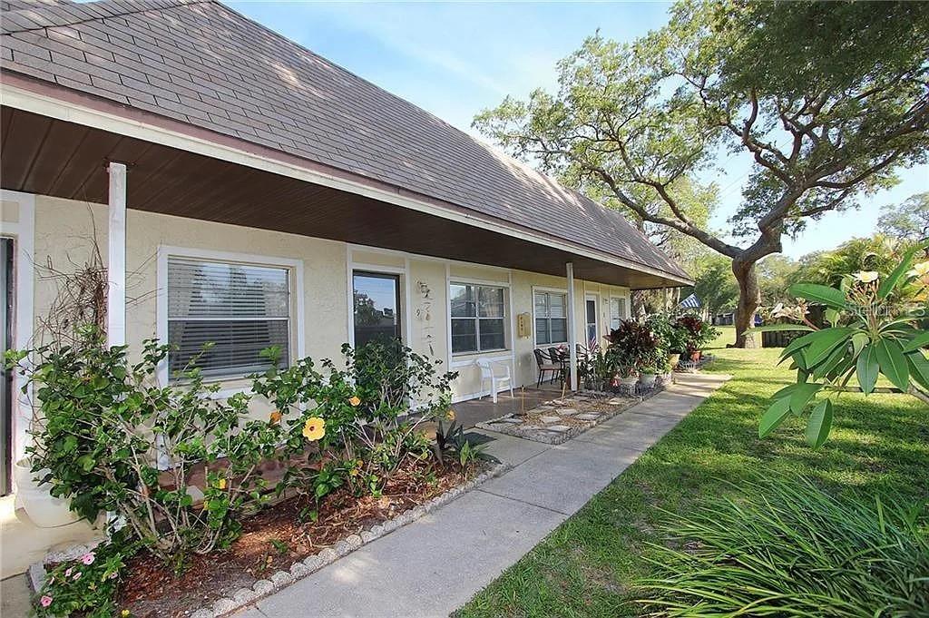 670 Green Valley Road, Unit F9 Palm Harbor, FL 34683 - Photo 1 of 22 a couple of table and chairs in the yard
