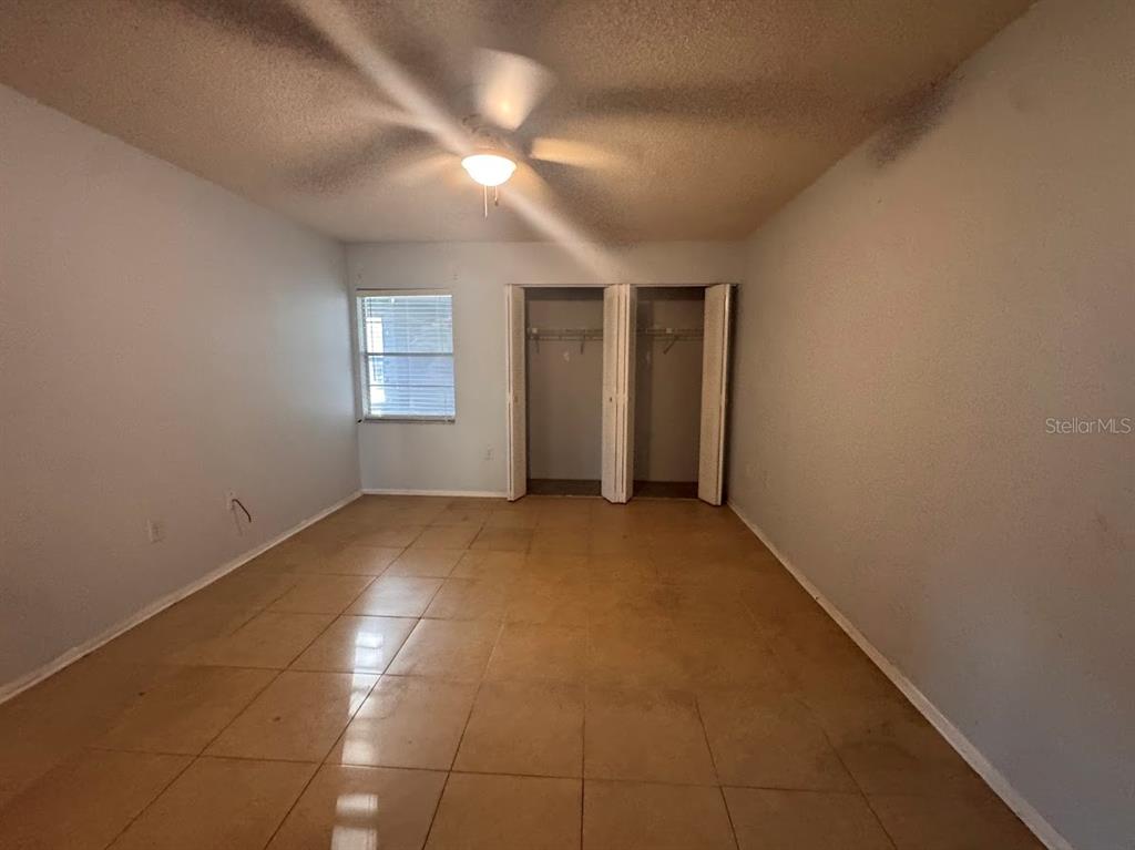670 Green Valley Road, Unit F9 Palm Harbor, FL 34683 - Photo 12 of 22 an empty room with a empty space and windows