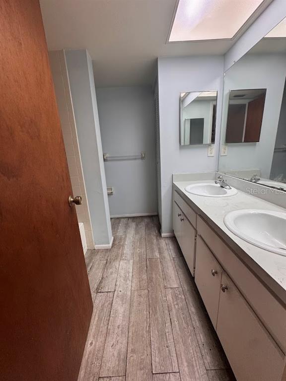 670 Green Valley Road, Unit F9 Palm Harbor, FL 34683 - Photo 13 of 22 a bathroom with a sink a mirror and a toilet