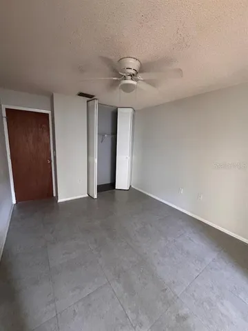 a view of a livingroom with a ceiling fan and window