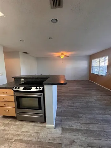 a stove top oven sitting inside of a kitchen