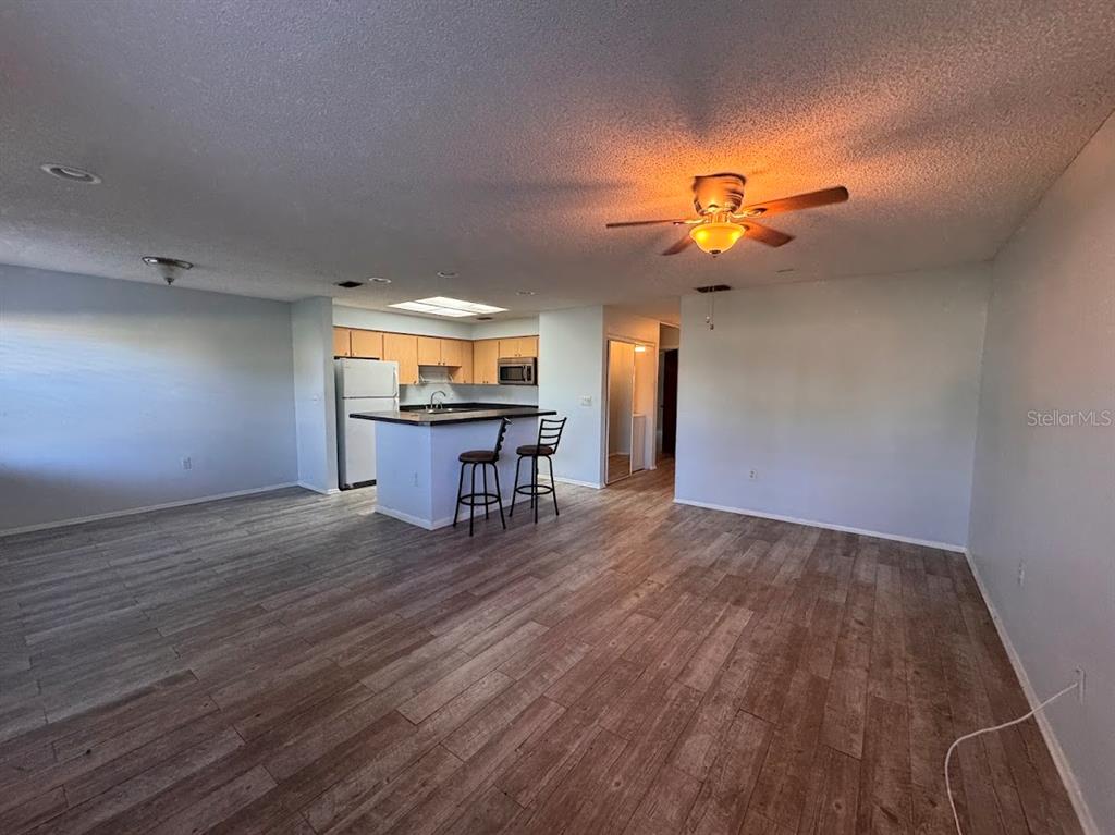 670 Green Valley Road, Unit F9 Palm Harbor, FL 34683 - Photo 9 of 22 a view of a livingroom with furniture and wooden floor