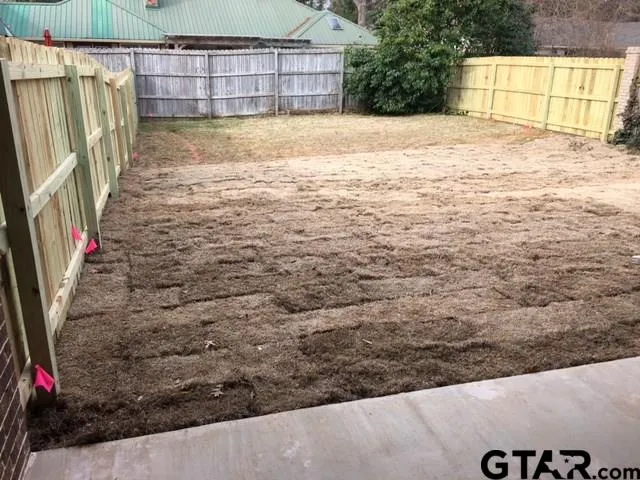 a view of a backyard of the house