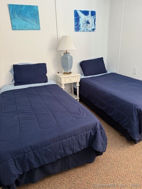 2144 Fairfield Beach Road Fairfield, CT 06824 - Photo 14 of 32 a bedroom with a bed and a night stand