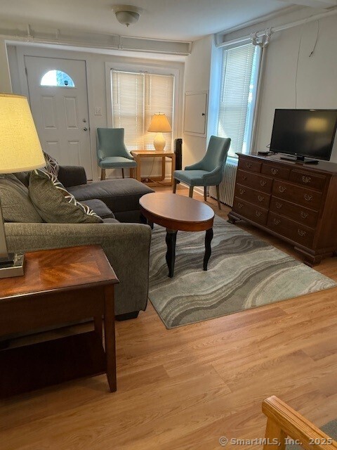 2144 Fairfield Beach Road Fairfield, CT 06824 - Photo 7 of 32 a living room with furniture and a flat screen tv