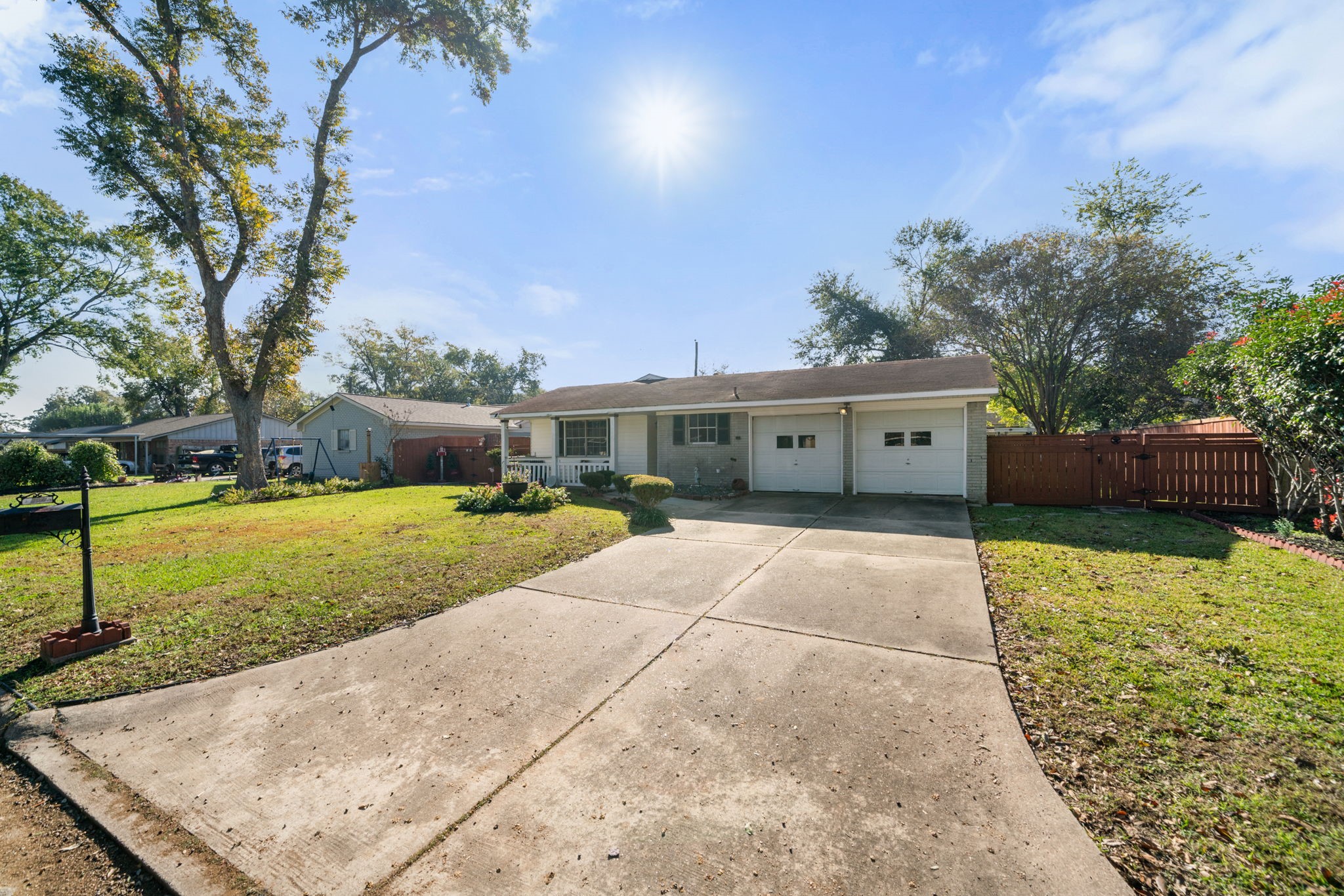 a front view of a house with a yard and a garden
