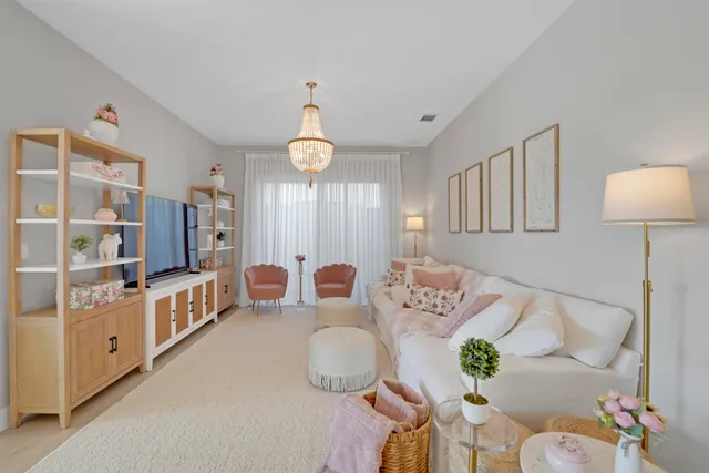 a kitchen with stainless steel appliances kitchen island granite countertop a sink a stove a refrigerator and chairs